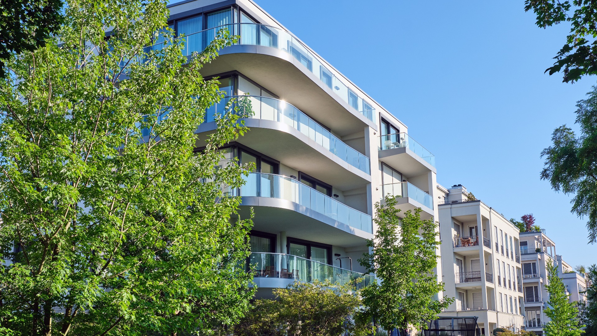 Modern apartment house with a green garden seen in Berlin, Germany